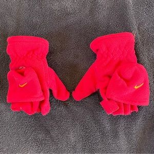 Pink Nike gloves that reveal the fingers for easy access.